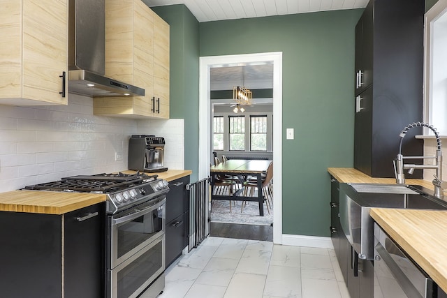 296 N Addison Ave, Elmhurst, IL 60126 - kitchen with wooden counters, wall chimney exhaust hood, appliances with stainless steel finishes, and light marble finish flooring