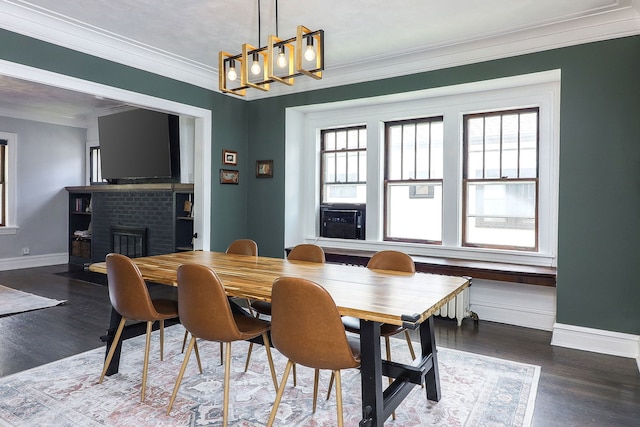 296 N Addison Ave, Elmhurst, IL 60126 - dining room with plenty of natural light, a brick fireplace, crown molding, wood finished floors, and a chandelier