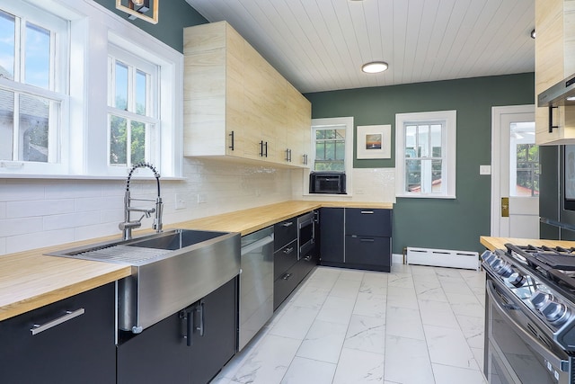 296 N Addison Ave, Elmhurst, IL 60126 - kitchen with wood counters, stainless steel appliances, a baseboard heating unit, light marble finish flooring, and plenty of natural light