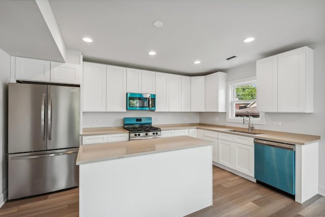3529 S 54th Ave, Cicero, IL 60804 - kitchen with stainless steel appliances, white cabinets, light countertops, a kitchen island, and recessed lighting