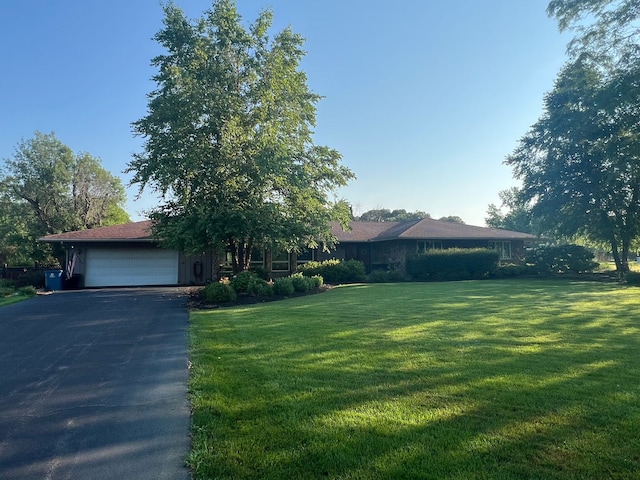 2108 E 1730 N Rd, Watseka, IL 60970 - view of front of house featuring an attached garage, asphalt driveway, and a front yard