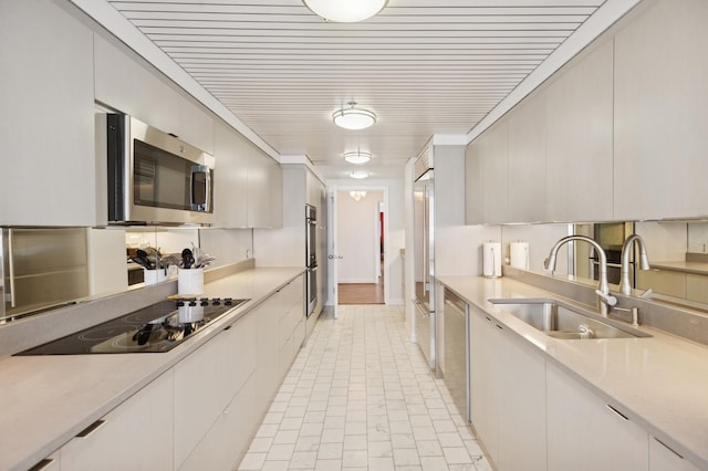 161 E Chicago Ave Unit 29De, Chicago, IL 60611 - kitchen featuring appliances with stainless steel finishes, light countertops, modern cabinets, and light tile patterned floors
