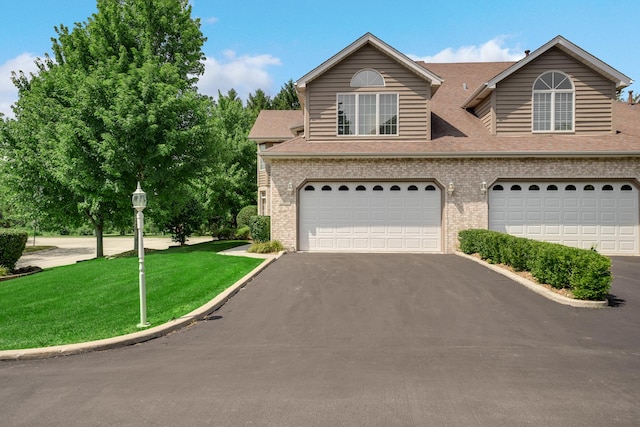 1 Moorings Dr, Palos Heights, IL 60463 - traditional-style home featuring asphalt driveway, brick siding, a front yard, an attached garage, and roof with shingles