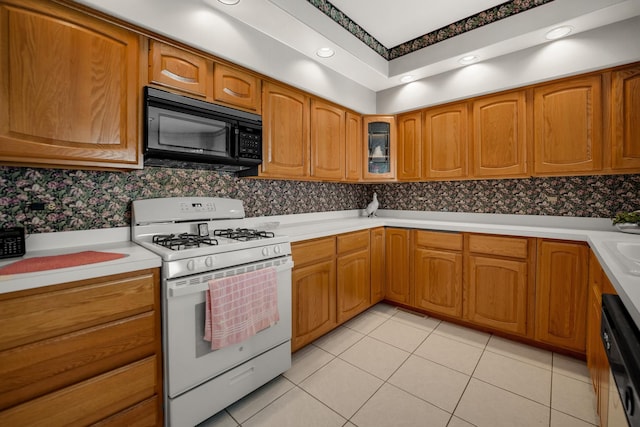 1 Moorings Dr, Palos Heights, IL 60463 - kitchen featuring white range with gas stovetop, black microwave, dishwashing machine, brown cabinetry, and recessed lighting