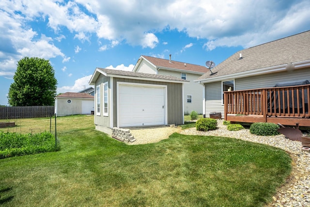 2030 Southfield Ln, Byron, IL 61010 - rear view of property featuring an outdoor structure, a deck, and a garage