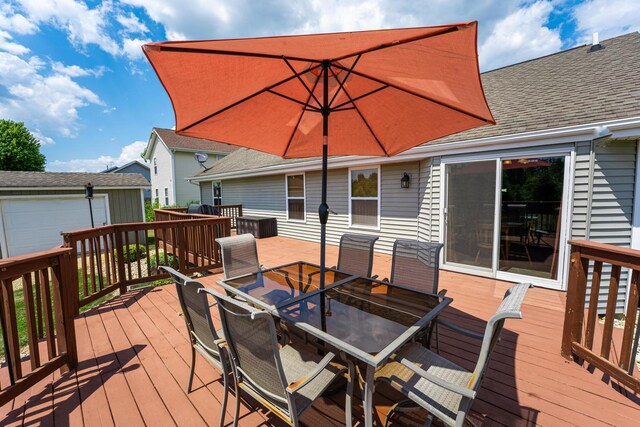 2030 Southfield Ln, Byron, IL 61010 - wooden terrace featuring outdoor dining space and an outbuilding