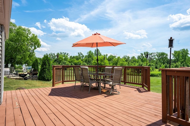 2030 Southfield Ln, Byron, IL 61010 - wooden terrace with outdoor dining space, a yard, and view of wooded area