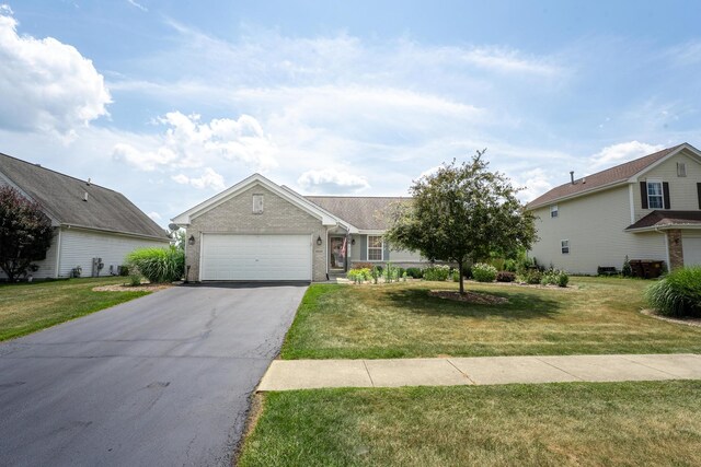 2030 Southfield Ln, Byron, IL 61010 - view of front of house featuring driveway, brick siding, an attached garage, and a front lawn