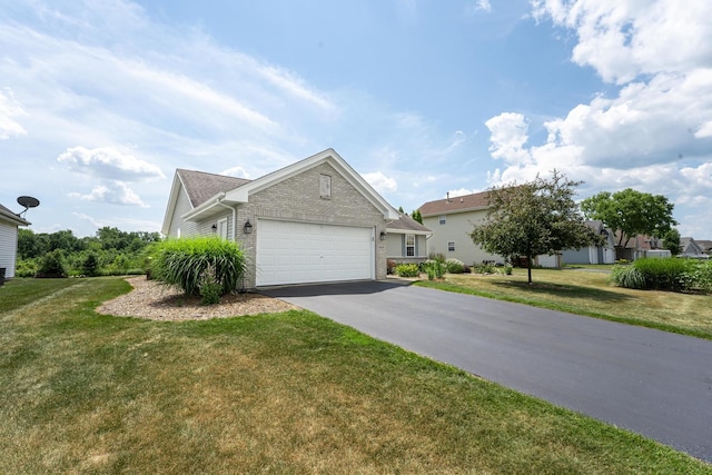 2030 Southfield Ln, Byron, IL 61010 - view of front of home featuring driveway, a garage, brick siding, and a front yard