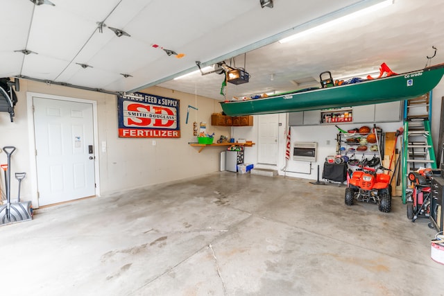 2030 Southfield Ln, Byron, IL 61010 - garage featuring a garage door opener and heating unit