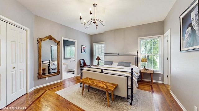 0N488 Baker Dr, Geneva, IL 60134 - bedroom with a chandelier, wood finished floors, ensuite bathroom, and a closet