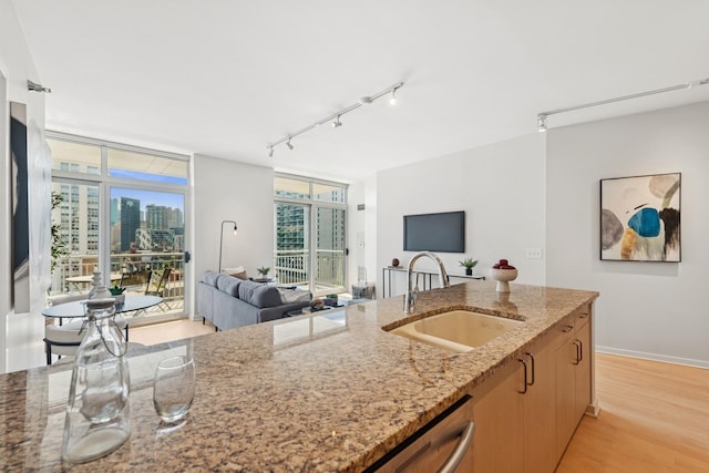 330 W Grand Ave Unit 1307, Chicago, IL 60654 - kitchen featuring expansive windows, track lighting, open floor plan, healthy amount of natural light, and light stone countertops