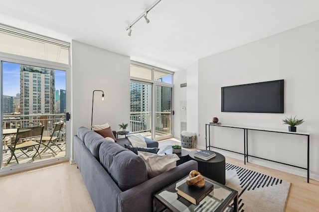330 W Grand Ave Unit 1307, Chicago, IL 60654 - living area featuring light wood-type flooring, rail lighting, expansive windows, and a city view