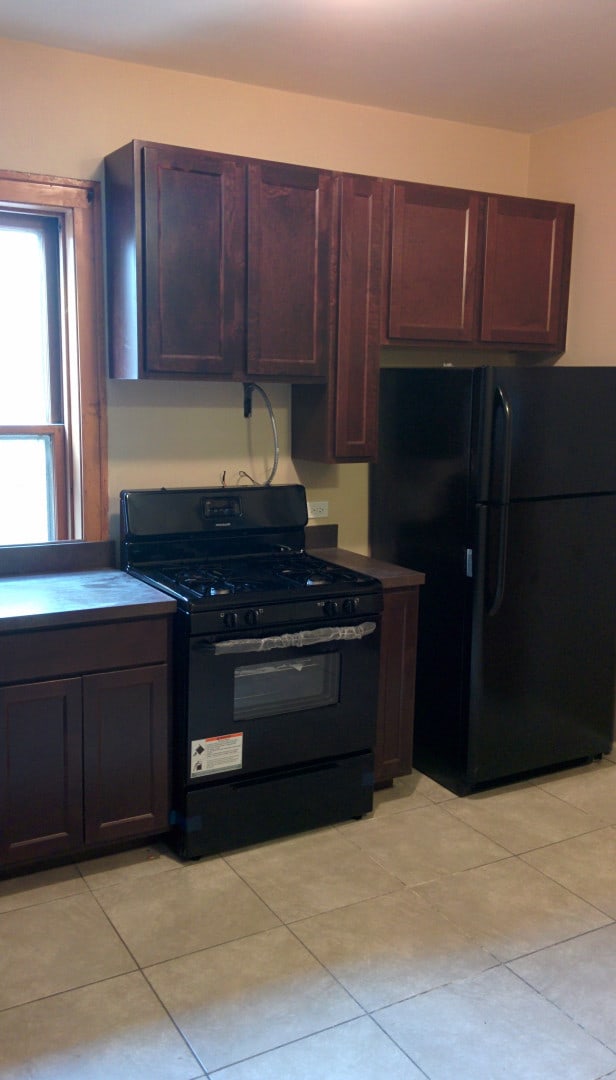 2244 W Augusta Blvd, Chicago, IL 60622 - kitchen featuring black appliances and light tile patterned floors