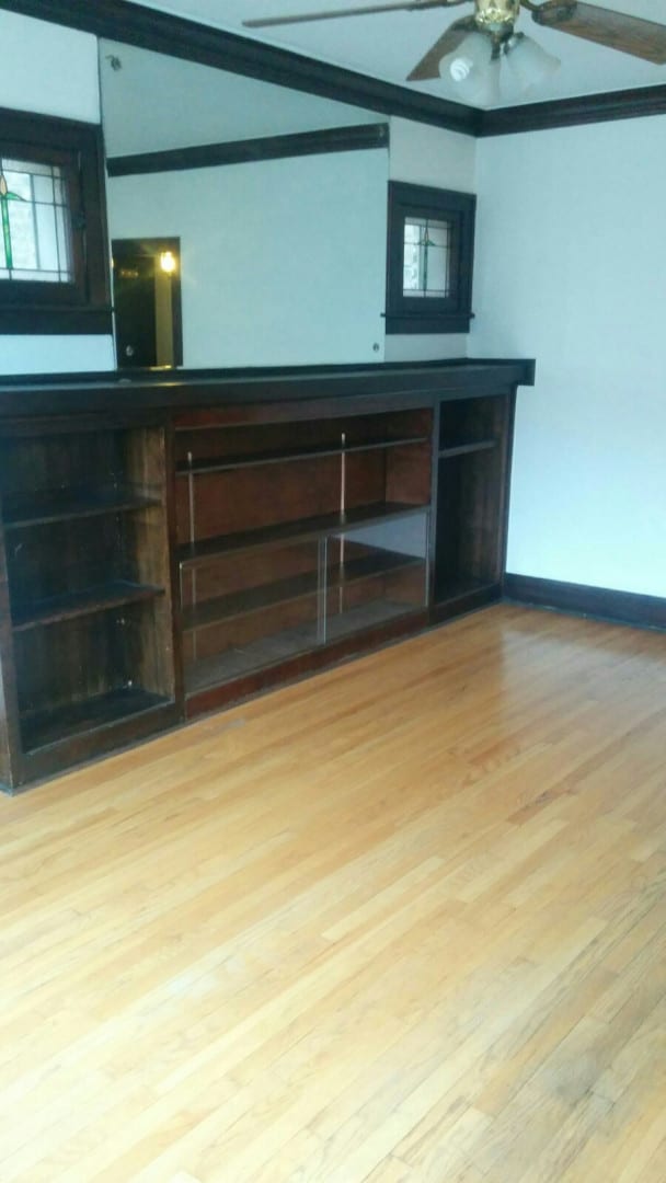 2244 W Augusta Blvd, Chicago, IL 60622 - unfurnished living room featuring crown molding, light wood-style floors, and ceiling fan