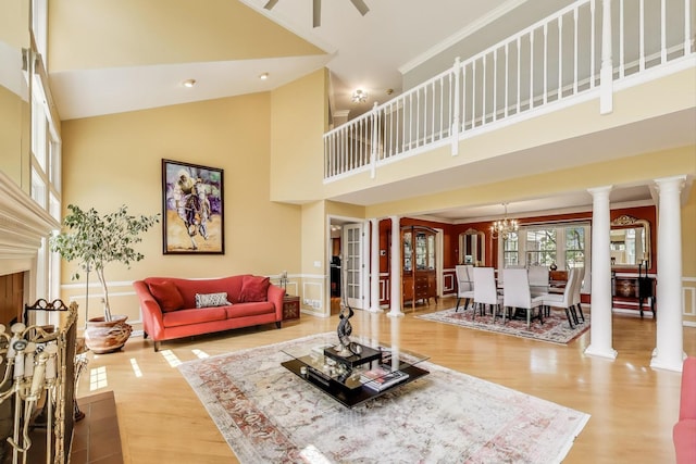 2114 Birchwood Ln, Buffalo Grove, IL 60089 - living area featuring a towering ceiling, ornate columns, wood finished floors, a chandelier, and a ceiling fan