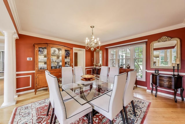 2114 Birchwood Ln, Buffalo Grove, IL 60089 - dining space featuring decorative columns, crown molding, light wood-style floors, a chandelier, and a wainscoted wall