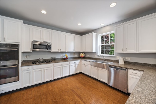 1616 Sutton Pl, Bolingbrook, IL 60490 - kitchen featuring appliances with stainless steel finishes, white cabinetry, recessed lighting, dark wood-type flooring, and dark stone countertops