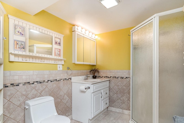 9049 Barberry Ln, Hickory Hills, IL 60457 - bathroom featuring tile walls, a stall shower, vanity, tile patterned flooring, and a wainscoted wall