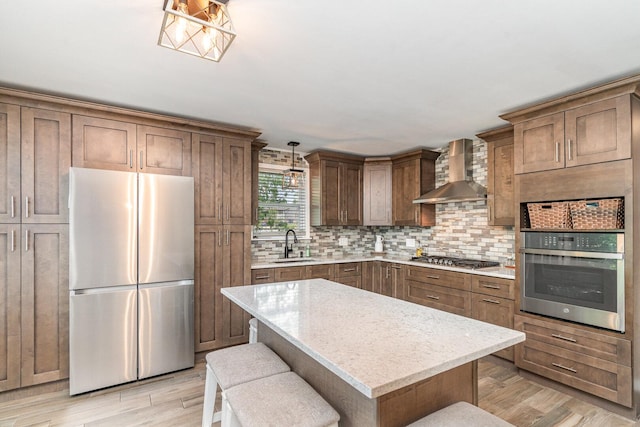 9049 Barberry Ln, Hickory Hills, IL 60457 - kitchen featuring stainless steel appliances, wall chimney exhaust hood, backsplash, and light wood-style flooring