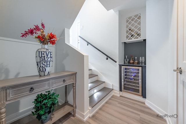 9130 S Greenwood Ave, Chicago, IL 60619 - staircase featuring beverage cooler, a bar, and wood finished floors