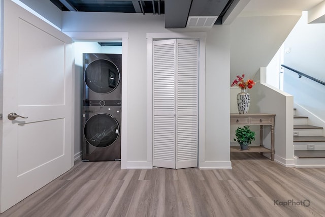 9130 S Greenwood Ave, Chicago, IL 60619 - laundry area with stacked washer / dryer and light wood-type flooring