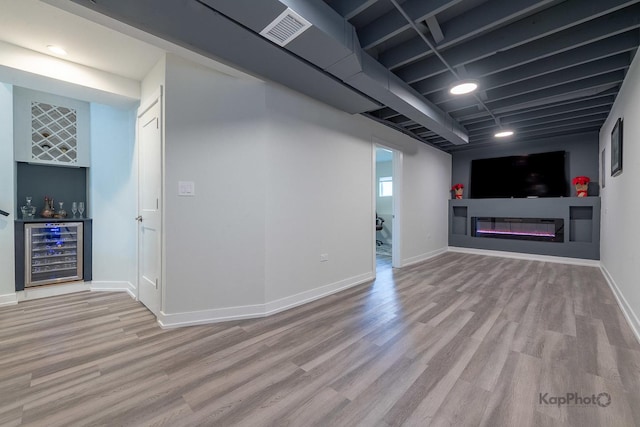9130 S Greenwood Ave, Chicago, IL 60619 - unfurnished living room with wine cooler, wood finished floors, a bar, and a glass covered fireplace