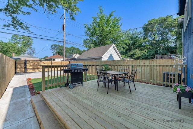 9130 S Greenwood Ave, Chicago, IL 60619 - wooden terrace with grilling area, outdoor dining area, and a fenced backyard