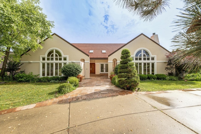 8170 Lake Ridge Dr, Burr Ridge, IL 60527 - mediterranean / spanish-style home featuring french doors, a front yard, stucco siding, and a chimney