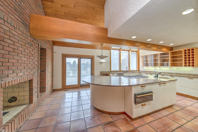 8170 Lake Ridge Dr, Burr Ridge, IL 60527 - kitchen with a warming drawer, white cabinetry, a center island with sink, recessed lighting, and light stone countertops
