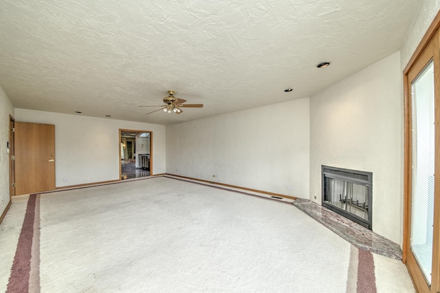 8170 Lake Ridge Dr, Burr Ridge, IL 60527 - unfurnished living room with carpet, a fireplace with raised hearth, ceiling fan, and a textured ceiling