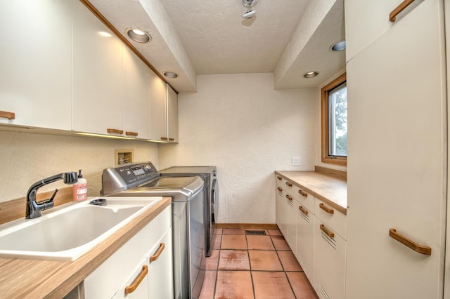 8170 Lake Ridge Dr, Burr Ridge, IL 60527 - laundry room with cabinet space, washing machine and clothes dryer, a textured ceiling, recessed lighting, and light tile patterned flooring