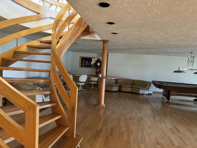 8170 Lake Ridge Dr, Burr Ridge, IL 60527 - living area featuring wood finished floors, stairway, billiards table, and a textured ceiling