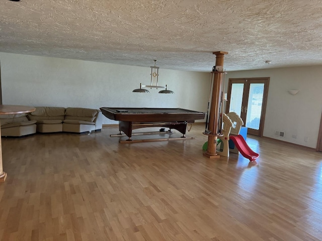 8170 Lake Ridge Dr, Burr Ridge, IL 60527 - playroom featuring wood finished floors, a textured ceiling, billiards table, and french doors