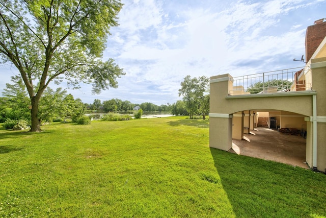 8170 Lake Ridge Dr, Burr Ridge, IL 60527 - view of grassy yard featuring a water view, a balcony, and a patio area