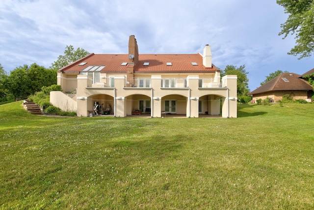 8170 Lake Ridge Dr, Burr Ridge, IL 60527 - back of property with a balcony, a lawn, a chimney, and stucco siding