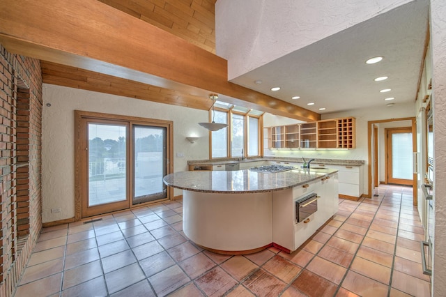 8170 Lake Ridge Dr, Burr Ridge, IL 60527 - kitchen featuring a textured wall, white cabinets, stainless steel gas stovetop, recessed lighting, and light tile patterned floors