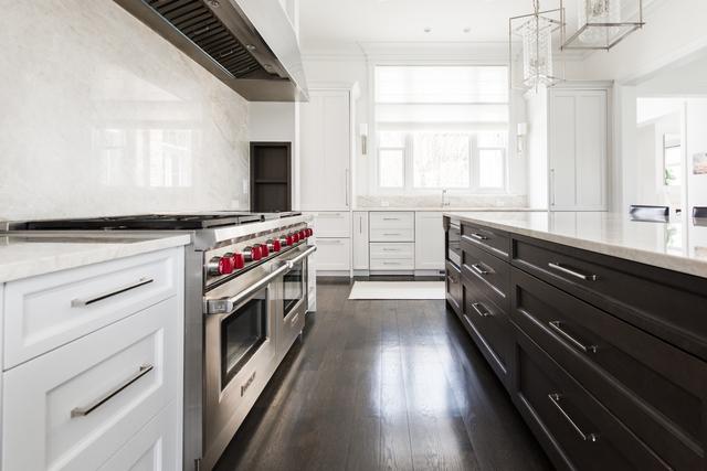 15W170 60th St, Burr Ridge, IL 60527 - kitchen featuring range with two ovens, white cabinetry, extractor fan, decorative light fixtures, and dark wood-style flooring
