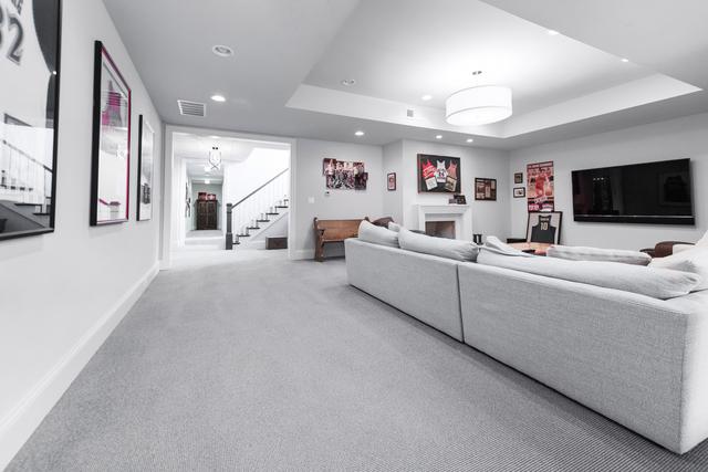 15W170 60th St, Burr Ridge, IL 60527 - living area featuring recessed lighting, carpet flooring, a tray ceiling, and stairs