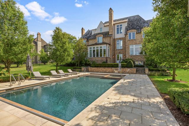 15W170 60th St, Burr Ridge, IL 60527 - view of swimming pool featuring a patio area, a yard, and a pool with connected hot tub