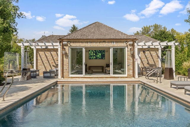 15W170 60th St, Burr Ridge, IL 60527 - view of swimming pool with a pergola, an exterior structure, an outbuilding, and a patio area