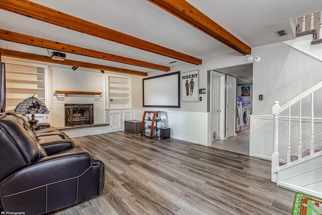 6414 180th St, Tinley Park, IL 60477 - living area with separate washer and dryer, stairs, wood finished floors, a wainscoted wall, and a brick fireplace