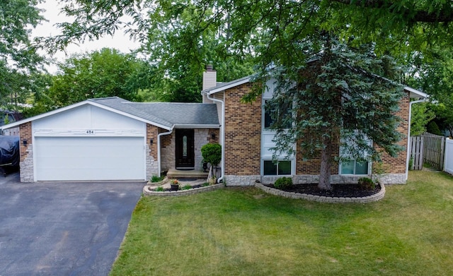 484 Valleyview Dr, Bartlett, IL 60103 - view of front of house featuring a garage, a chimney, driveway, and stone siding