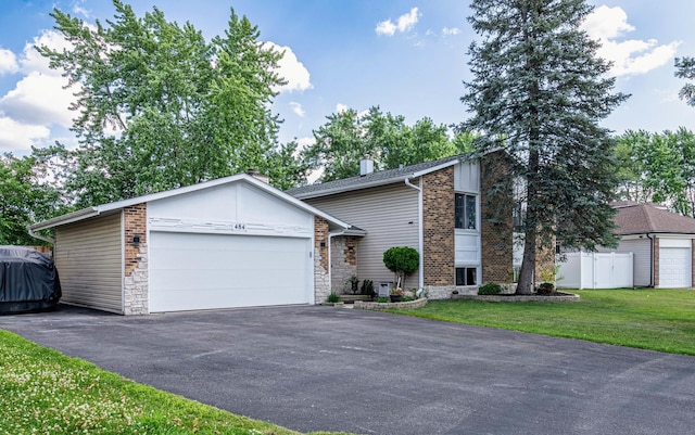 484 Valleyview Dr, Bartlett, IL 60103 - mid-century home with a garage, driveway, and a chimney