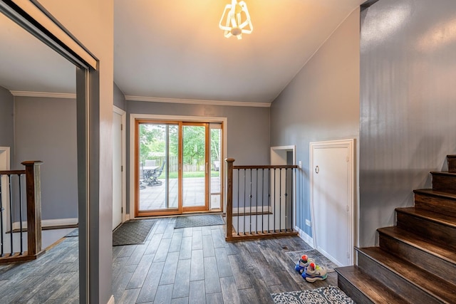 484 Valleyview Dr, Bartlett, IL 60103 - entrance foyer featuring dark wood-style flooring, a chandelier, vaulted ceiling, ornamental molding, and stairs