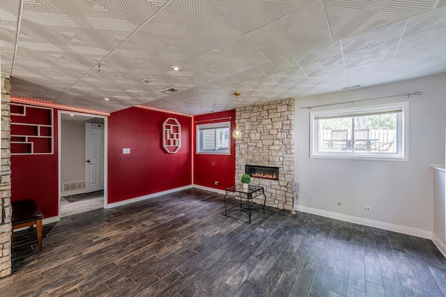 484 Valleyview Dr, Bartlett, IL 60103 - unfurnished living room featuring a stone fireplace and wood finished floors