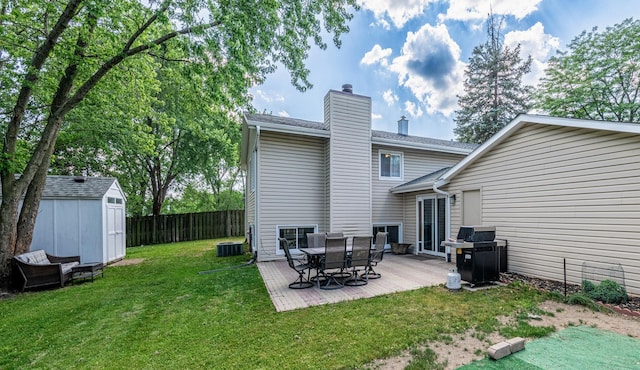 484 Valleyview Dr, Bartlett, IL 60103 - rear view of house featuring a chimney, a storage unit, and a wooden deck