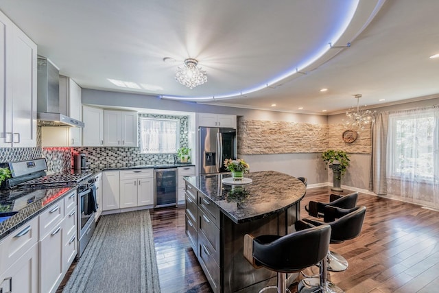 484 Valleyview Dr, Bartlett, IL 60103 - kitchen with appliances with stainless steel finishes, beverage cooler, a chandelier, and wall chimney exhaust hood