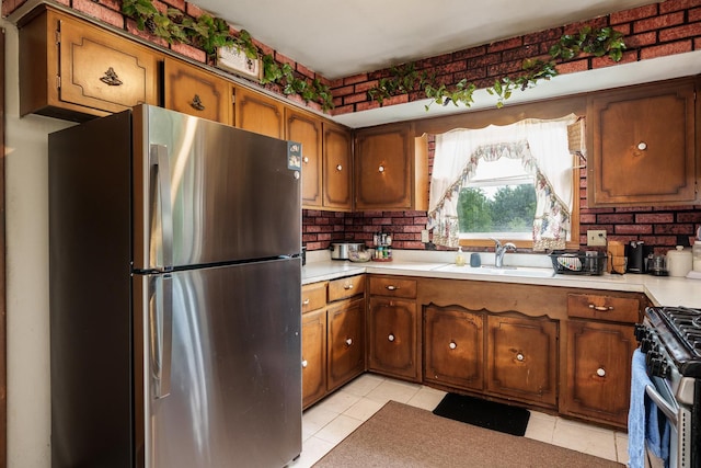 6650 Happy Acres Rd, Rockford, IL 61101 - kitchen with appliances with stainless steel finishes, light countertops, brown cabinets, and light tile patterned floors