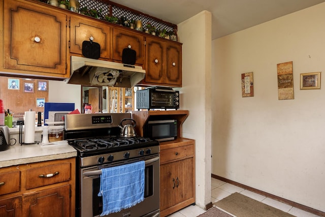 6650 Happy Acres Rd, Rockford, IL 61101 - kitchen featuring stainless steel appliances, under cabinet range hood, brown cabinetry, and light countertops
